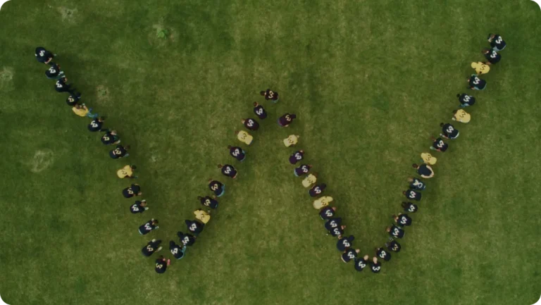 Wincent employees forming a W on a field — Culture at Wincent