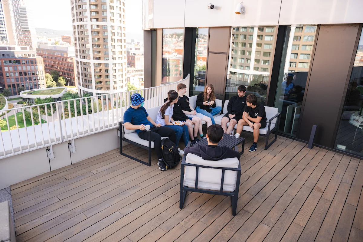 Interns sitting together on the office roof terrace above Bratislava