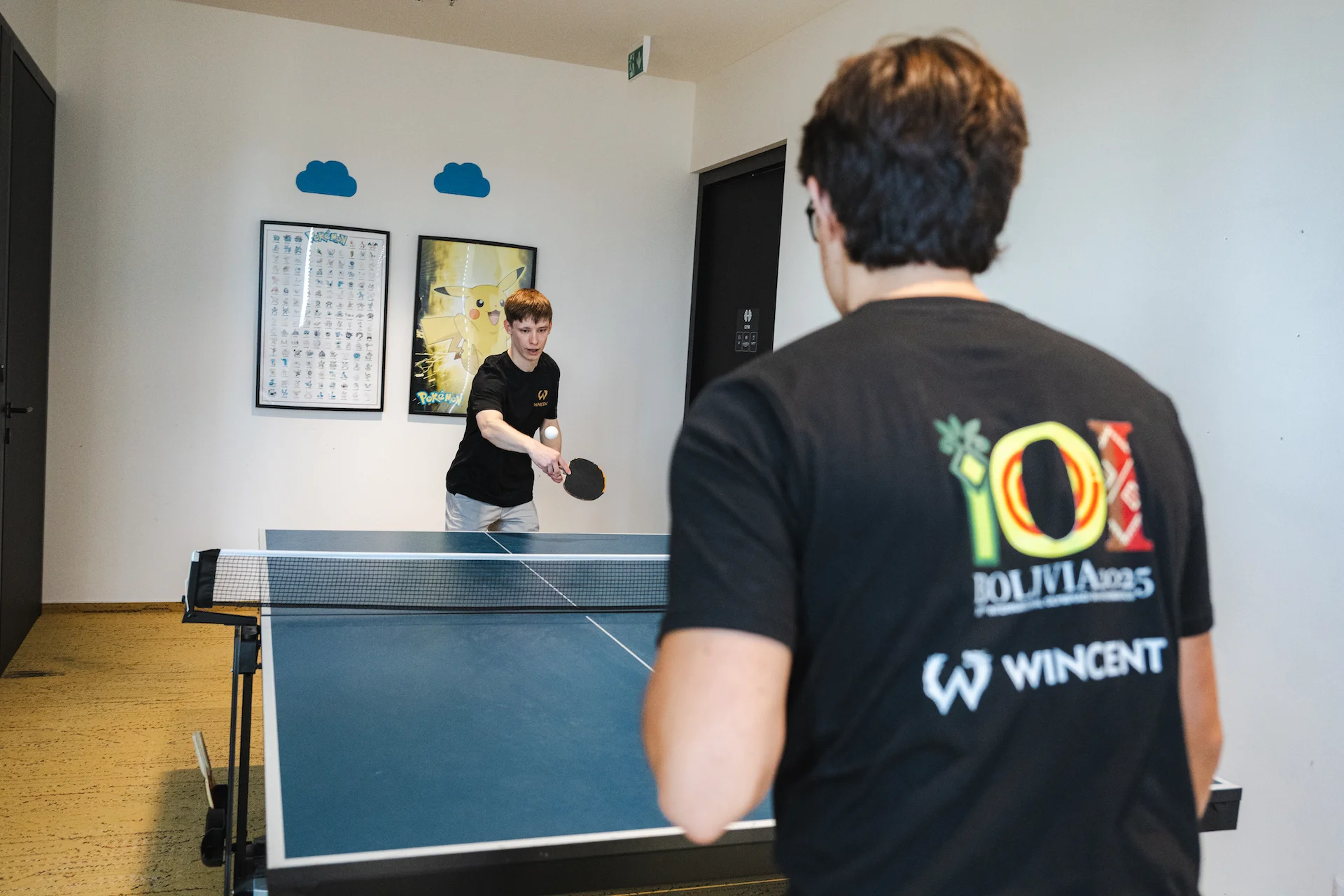 Two interns playing table tennis in the office